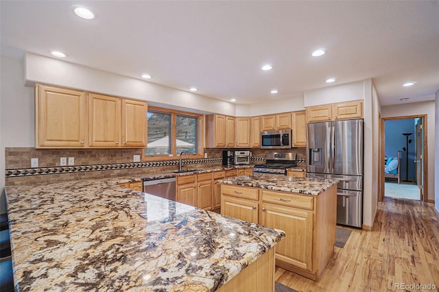 31755 Ponderosa Way, Evergreen, CO 80439 - kitchen with stainless steel appliances, stone counters, light wood-style flooring, a peninsula, and tasteful backsplash