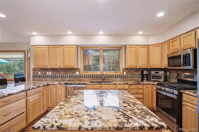 31755 Ponderosa Way, Evergreen, CO 80439 - kitchen with stainless steel appliances, light brown cabinets, recessed lighting, light stone countertops, and tasteful backsplash