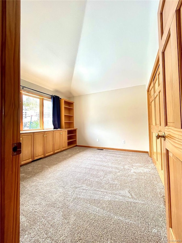 31755 Ponderosa Way, Evergreen, CO 80439 - unfurnished living room featuring carpet flooring and vaulted ceiling