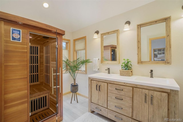 31755 Ponderosa Way, Evergreen, CO 80439 - bathroom with a sauna / steam room, double vanity, and wood finished floors