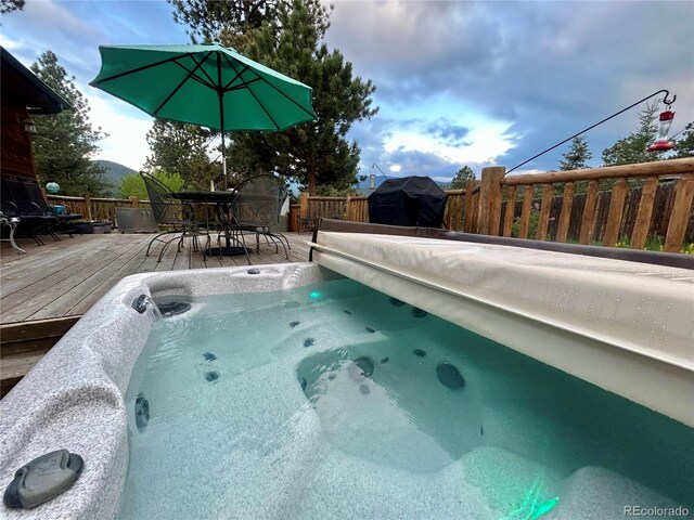 31755 Ponderosa Way, Evergreen, CO 80439 - view of pool with a wooden deck, grilling area, outdoor dining area, and a hot tub
