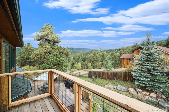 31755 Ponderosa Way, Evergreen, CO 80439 - wooden terrace with a wooded view