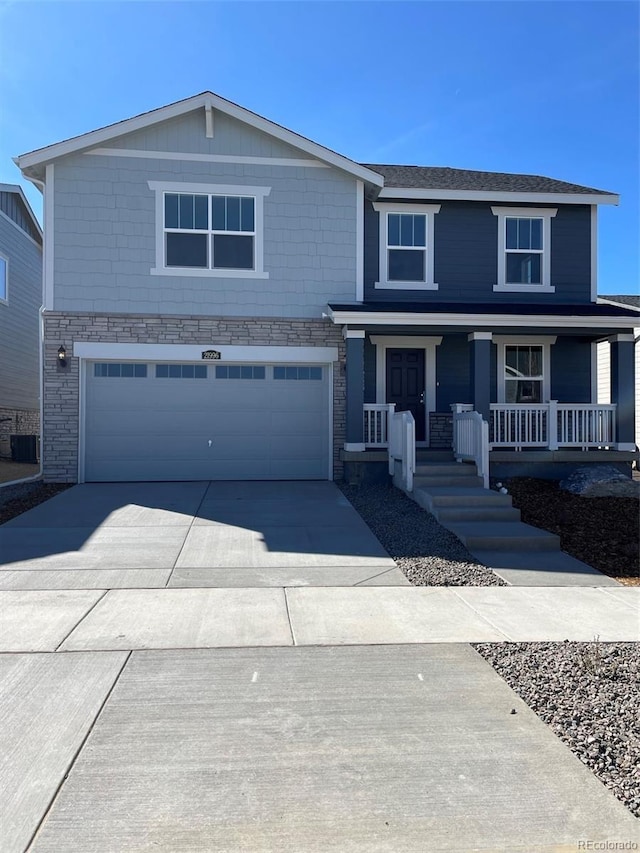 21996 E 39th Pl, Aurora, CO 80019 - view of front of home featuring a garage, concrete driveway, stone siding, a porch, and central AC unit