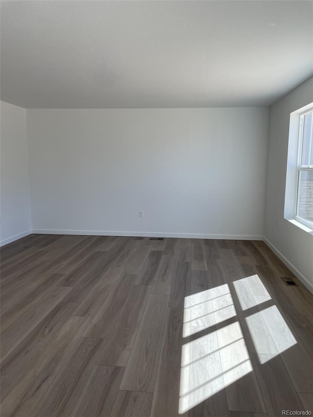 21996 E 39th Pl, Aurora, CO 80019 - spare room with dark wood-style floors and baseboards