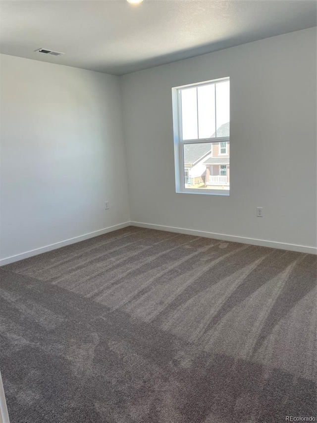 21996 E 39th Pl, Aurora, CO 80019 - unfurnished room featuring dark colored carpet and baseboards