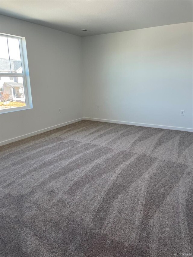 21996 E 39th Pl, Aurora, CO 80019 - carpeted spare room with baseboards