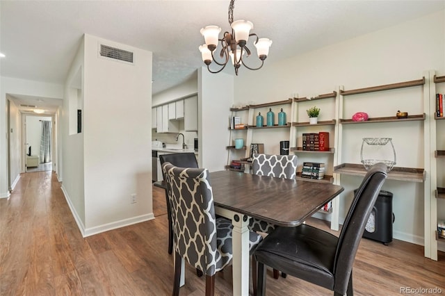 7305 S Xenia Cir Unit E, Centennial, CO 80112 - dining space with a chandelier and wood finished floors