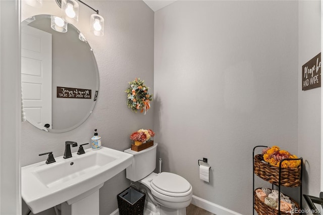 2576 Villageview Ln, Castle Rock, CO 80104 - half bath with toilet, a sink, and baseboards