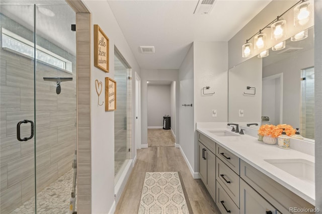 2576 Villageview Ln, Castle Rock, CO 80104 - full bath with double vanity, a stall shower, wood finished floors, and baseboards