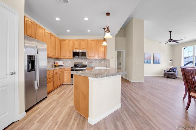 1194 Red Lodge Dr Unit 201, Evergreen, CO 80439 - kitchen with decorative backsplash, decorative light fixtures, appliances with stainless steel finishes, light wood-style floors, and recessed lighting