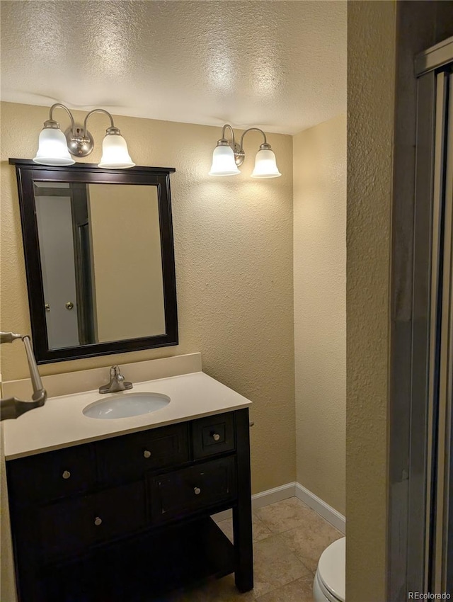 8060 E Girard Ave Unit 910, Denver, CO 80231 - bathroom featuring vanity, a textured ceiling, tile patterned flooring, and a textured wall