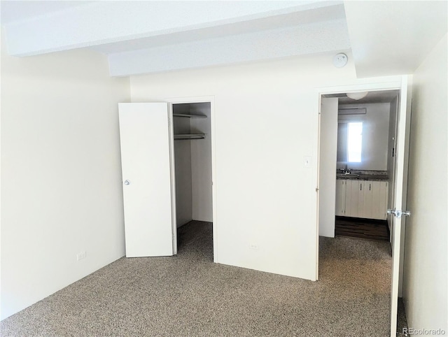 8060 E Girard Ave Unit 910, Denver, CO 80231 - unfurnished bedroom featuring carpet and a spacious closet