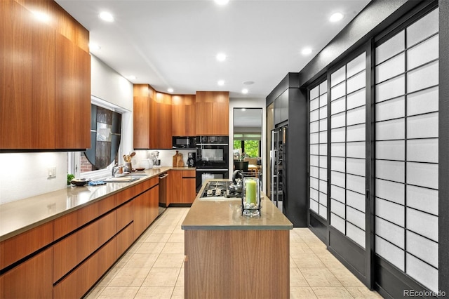 2800 S University Blvd Unit 19, Denver, CO 80210 - kitchen featuring modern cabinets, a center island, black appliances, recessed lighting, and light countertops