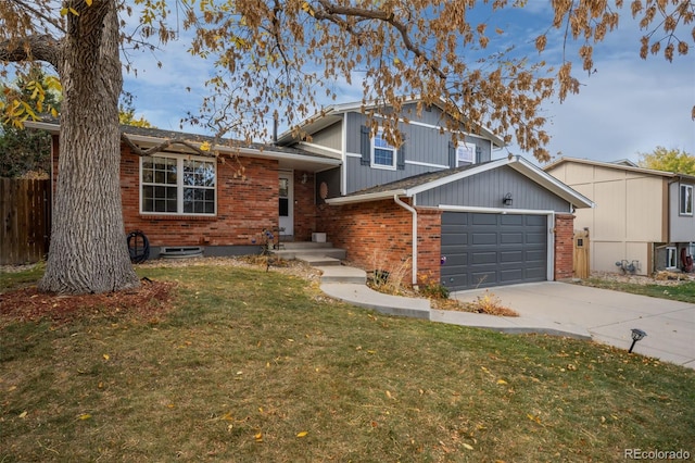 tri-level home featuring a front yard and a garage