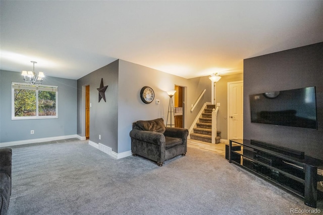 carpeted living room with a chandelier