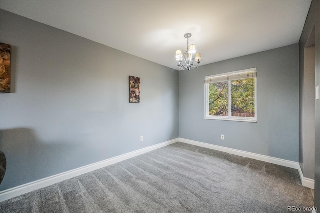 unfurnished room with a notable chandelier and carpet flooring