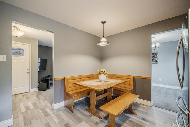 dining area featuring a notable chandelier and light hardwood / wood-style floors