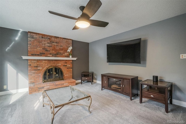 carpeted living room with a fireplace, a textured ceiling, and ceiling fan