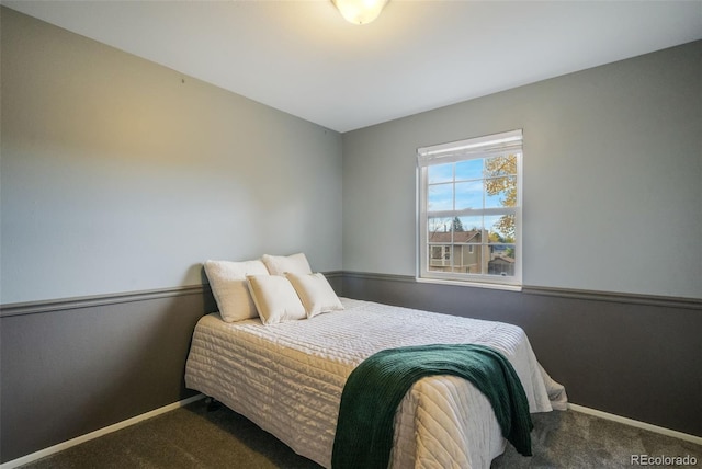 bedroom with dark colored carpet