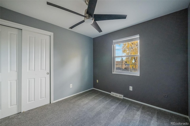 unfurnished bedroom featuring carpet floors, a closet, and ceiling fan