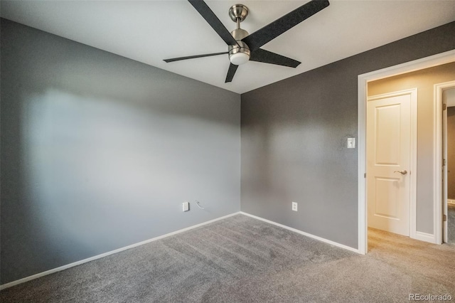 empty room featuring light carpet and ceiling fan