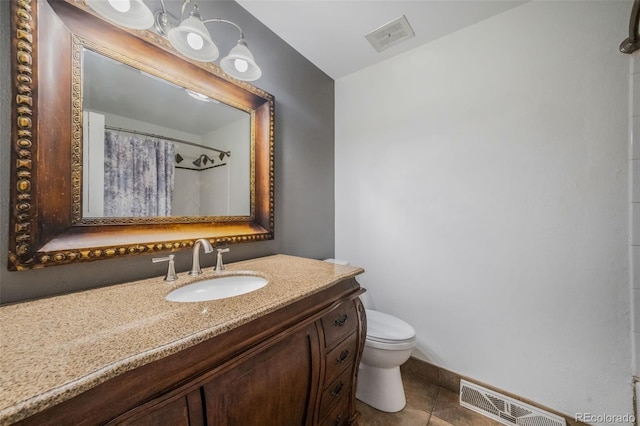 bathroom featuring vanity, a shower with curtain, toilet, and tile patterned floors