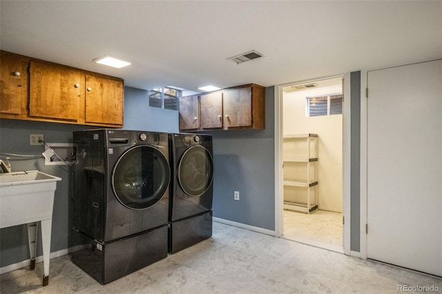 washroom featuring cabinets and independent washer and dryer