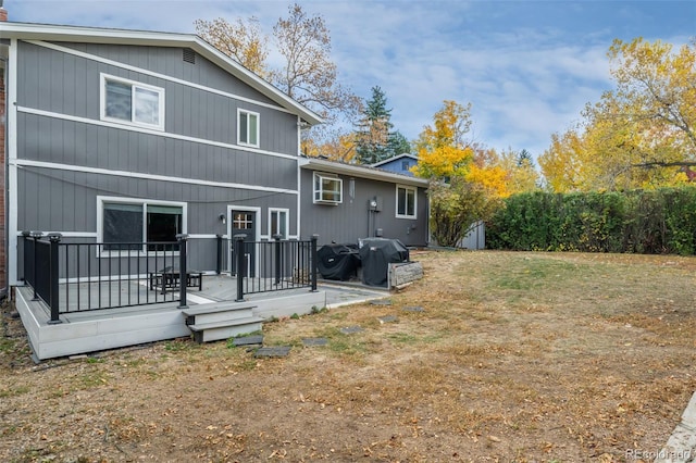 back of property with a wooden deck and a shed