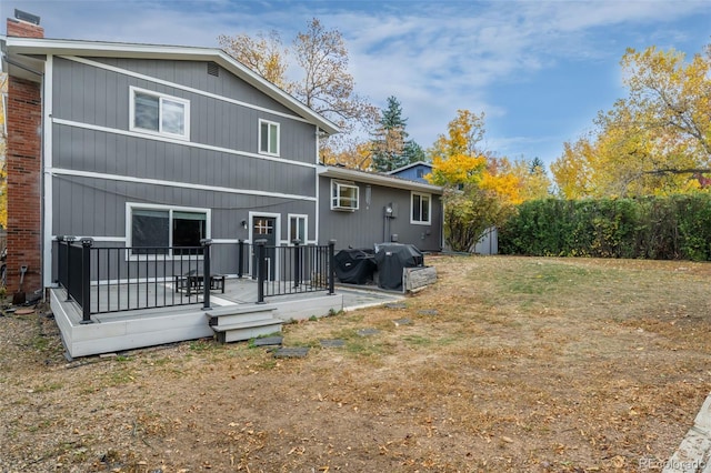 back of house featuring a deck and a storage unit