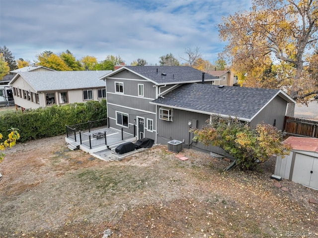 rear view of property with a deck and central AC