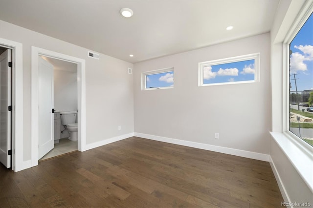 2010 Irving St, Denver, CO 80211 - unfurnished bedroom with dark wood finished floors, multiple windows, recessed lighting, and connected bathroom