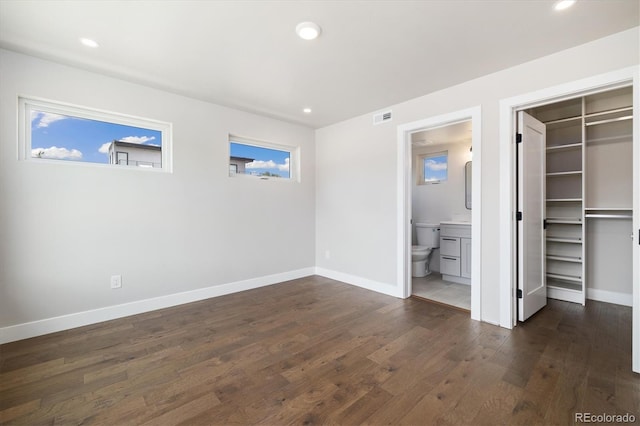 2010 Irving St, Denver, CO 80211 - unfurnished bedroom with dark wood-type flooring, multiple windows, a walk in closet, recessed lighting, and ensuite bathroom