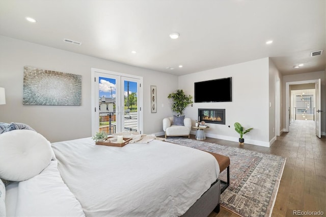 2010 Irving St, Denver, CO 80211 - bedroom with access to outside, recessed lighting, wood finished floors, and a glass covered fireplace