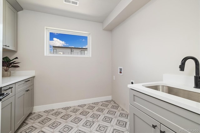 2010 Irving St, Denver, CO 80211 - laundry area with hookup for a washing machine, hookup for an electric dryer, light flooring, and cabinet space