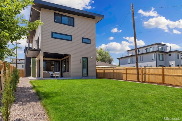 2010 Irving St, Denver, CO 80211 - rear view of house with a balcony, a fenced backyard, a patio, and outdoor lounge area