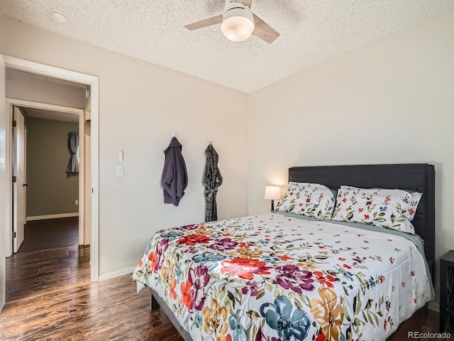 bedroom featuring a ceiling fan, a textured ceiling, baseboards, and wood finished floors