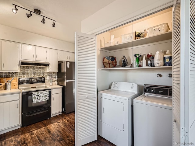 laundry area with washing machine and dryer and dark wood-type flooring