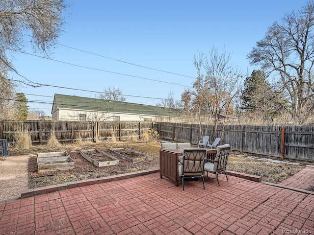 view of patio / terrace featuring a garden and a fenced backyard