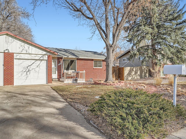 view of front of home featuring an attached garage, a porch, concrete driveway, and brick siding