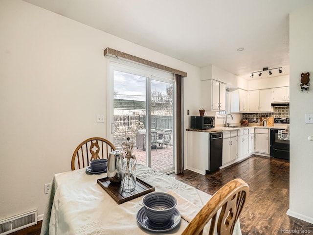 dining space featuring baseboards, visible vents, and dark wood-type flooring