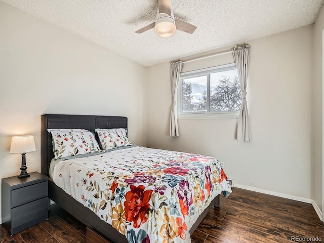 bedroom featuring a ceiling fan, a textured ceiling, baseboards, and wood finished floors