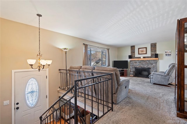 living room with carpet flooring, a chandelier, and a fireplace