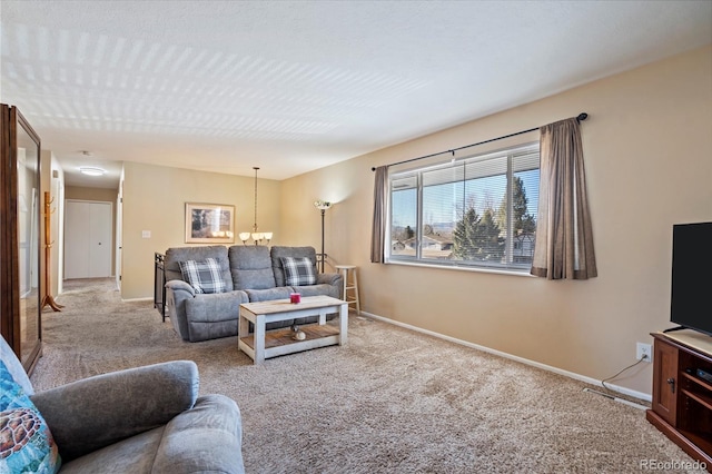 living room with light carpet and a notable chandelier