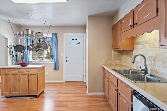 kitchen featuring tasteful backsplash, sink, light hardwood / wood-style flooring, and dishwasher