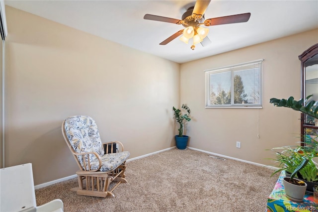 living area featuring carpet floors and ceiling fan