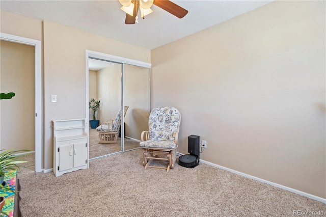 living area featuring ceiling fan and light colored carpet