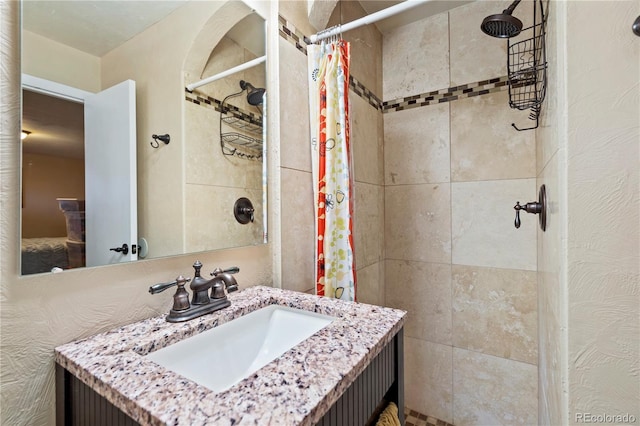 bathroom featuring vanity and curtained shower