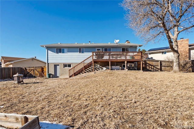 rear view of house featuring a wooden deck