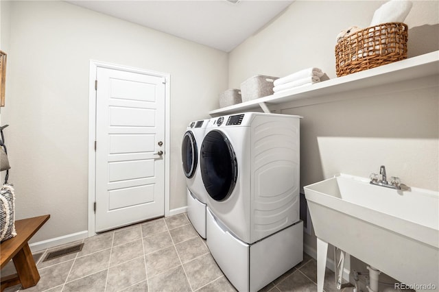 laundry room featuring independent washer and dryer, tile patterned floors, and sink