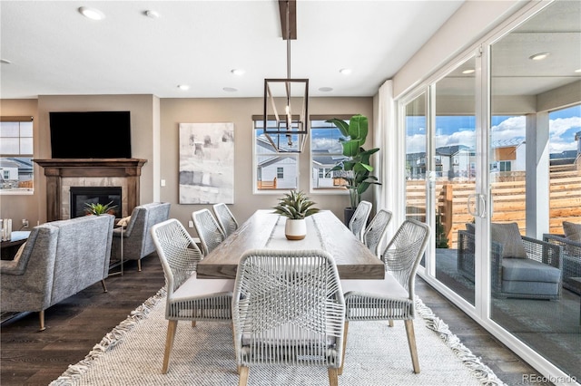 dining space with a high end fireplace and dark hardwood / wood-style floors